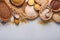 White, brown and red rice, buckwheat, millet, corn groats, quinoa and bulgur in wooden bowls on the light gray kitchen table. Glut