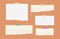 White and brown ripped lined paper strips, notebook, note for text or message stuck with colorful sticky tape on orange