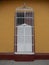 WHITE AND BROWN WOODEN WINDOW ON ORANGE FACADE, TRINIDAD, CUBA