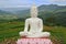 White Buddha image with mountain view background