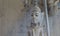 White buddha statue under a umbrella in closeup, a spiritual or buddhist background