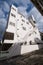 White building and an emergency stair at the front with cloudy sky