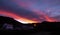 White building at late afternoon with impressive orange and red sky in Copahue, NeuquÃ©n, Argentina.