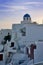 White buildings and blue domed chapel in Santorini Greece