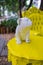 White bulldog statuette on vintage yellow table and armchair in park