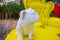 White bulldog statuette on vintage yellow table and armchair in park