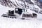 White bulldozer clearing deep snow