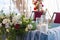 White and Burgundy floral arrangements in the summer tent