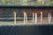 White burning candles stand on the sand