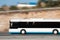 White bus moving fast along the street on a motion blurred background. Bus driving on freeway