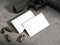 White business cards on concrete floor with gun and bullets. rendering