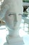 White bust of young woman in the Mall bust of an ancient woman with false eyelashes and arrows