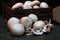 White button mushrooms stacked in front of a crate