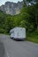 White camper car driving in the mountains. Adventurous lifestyle. Camper life. Travel in mountains