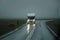 White camper driving on a road - front view