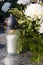 White candle and artificial flowers on a grave