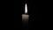 White candle on a black background