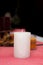 The white candle stands on the table. Festive composition with candles. Christmas table decoration. A beautiful table setting.