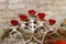 white candlestick with red roses