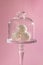 White candy balls, coconut pralines dessert, beautiful glass stand, delicate pink background, exquisite dessert gift