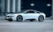 white car BMW i8 is driving fast on the street. Plug-in hybrid sports car in motion