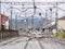 White car crossing a level crossing over the train tracks at the entrance of the Monforte de Lemos station