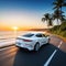 A white car drives off into the sunset along the road to the ocean