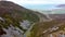 White car driving through Gap of Mamore, Inishowen Peninsula in County Donegal - Republic of Ireland