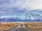 A white car driving on an unpaved road near Lake Tekapo in Otago region of the South Island of New Zealand