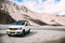 White car parked in highland mountain scene in Leh, India