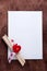 White card with a small red heart on wooden background
