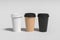 White, cardboard and black take away coffee paper cups mock up with lids on white background