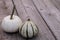 White Casper pumpkin next to green and white gourd