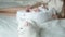 White cat in the foreground is lying in the bedroom on the bed of the newborn and the mother. Mother and child in the