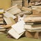 White cat with heterochromia iridis peeking behind a pile of books