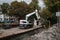 White Cat industrial digger floating on a raft barge on a river canal and excavating the bank