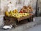 White cat beside simple fruit stall in Stone Town street, Zanzibar