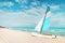 white catamaran blue sail on white sandy beach with retro effect. beach of Varadero in Cuba