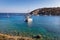 White catamaran docked in ancient bay of Knidos against blue sky