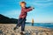 White Caucasian children kids friends playing running on ocean sea beach on sunset outdoors