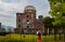 White caucasian young man standing and staring at the atomic bomb dome in Hiroshima, Japan, Asia