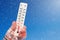 White celsius and fahrenheit scale thermometer in hand. Ambient temperature minus 17 degrees