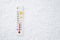 White celsius scale thermometer in snow. Ambient temperature minus 1 degrees