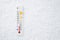 White celsius scale thermometer in snow. Ambient temperature minus 13 degrees