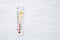 White celsius scale thermometer in snow. Ambient temperature minus 3 degrees