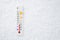 White celsius scale thermometer in snow. Ambient temperature minus 5 degrees