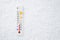 White celsius scale thermometer in snow. Ambient temperature minus 6 degrees