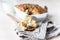 White ceramic baking dish with healthy vegan crumble cake, light concrete background.