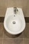 White ceramic bidet in modern bathroom. Close up. Detail