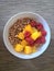White Ceramic Bowl with Dry O Cereal, Raspberries and Mango Chunks